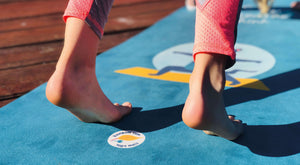 Children playing on a rainbow gum yoga mat while breathing and doing the sun salutation on their premium yoga mat.